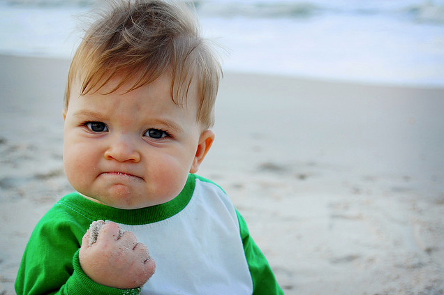 success kid little boy fist on beach